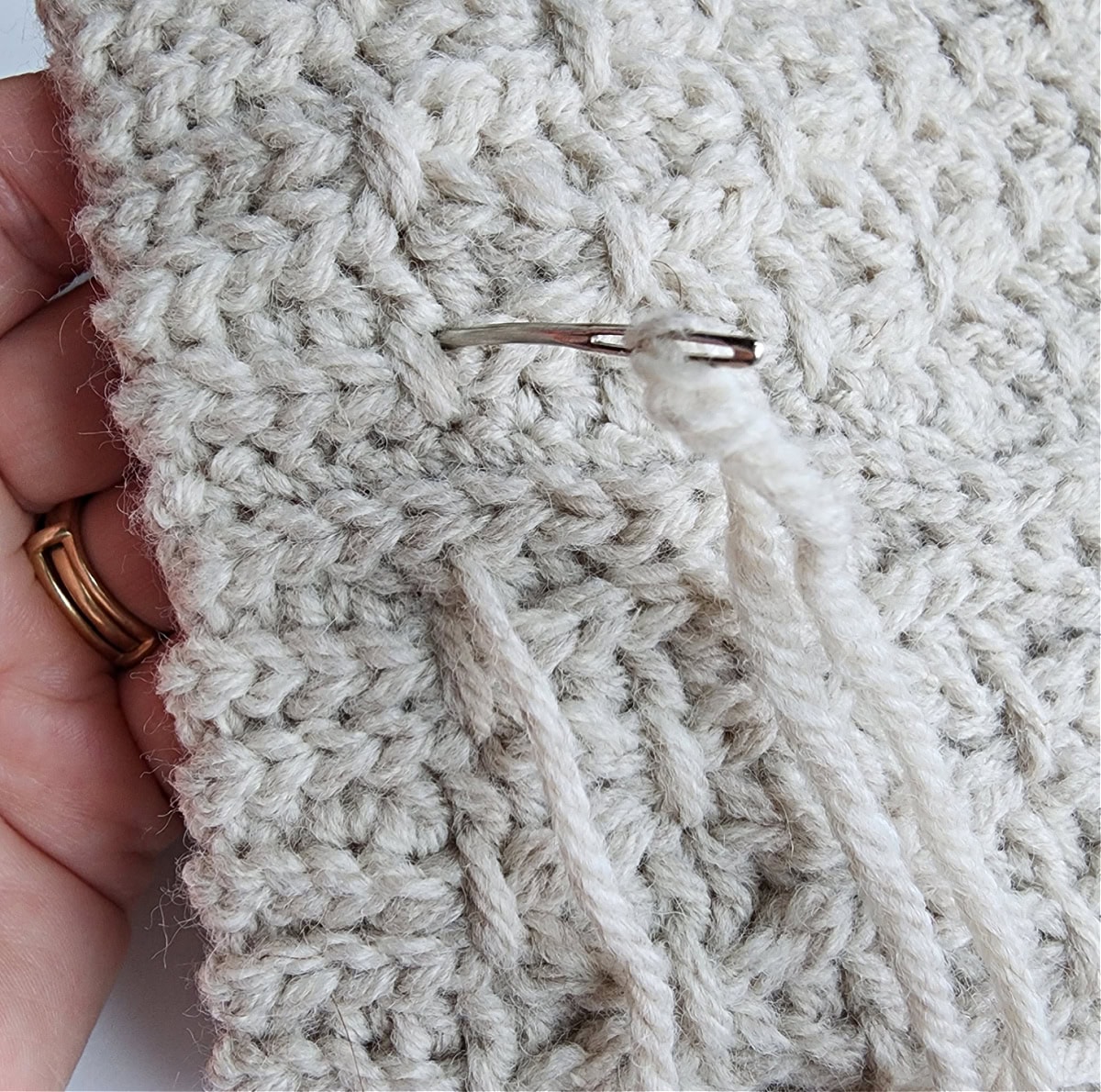 A yarn needle close-up to show where to connect the finishing stitch.