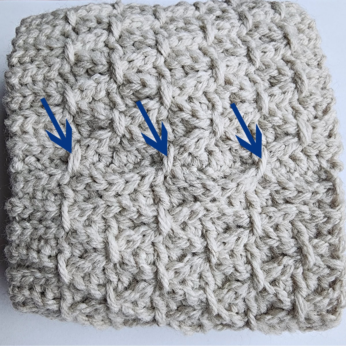 Three blue arrows pointing to three complete finishing stitches.