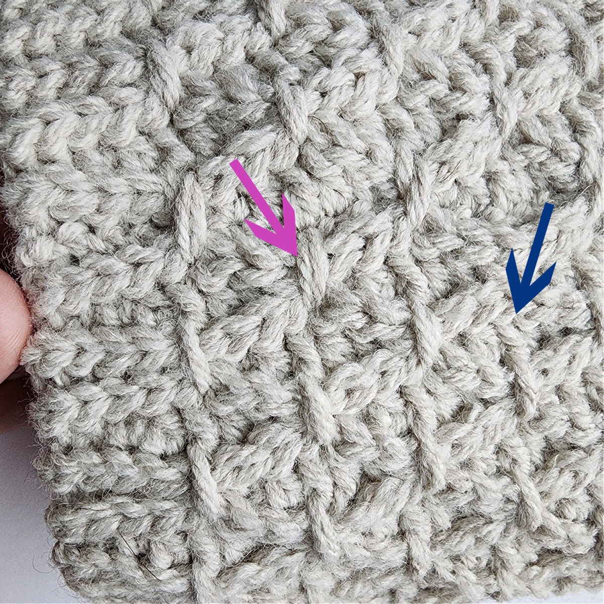 The pink arrow shows one finishing stitch complete and the blue arrow shows where to work the next one.