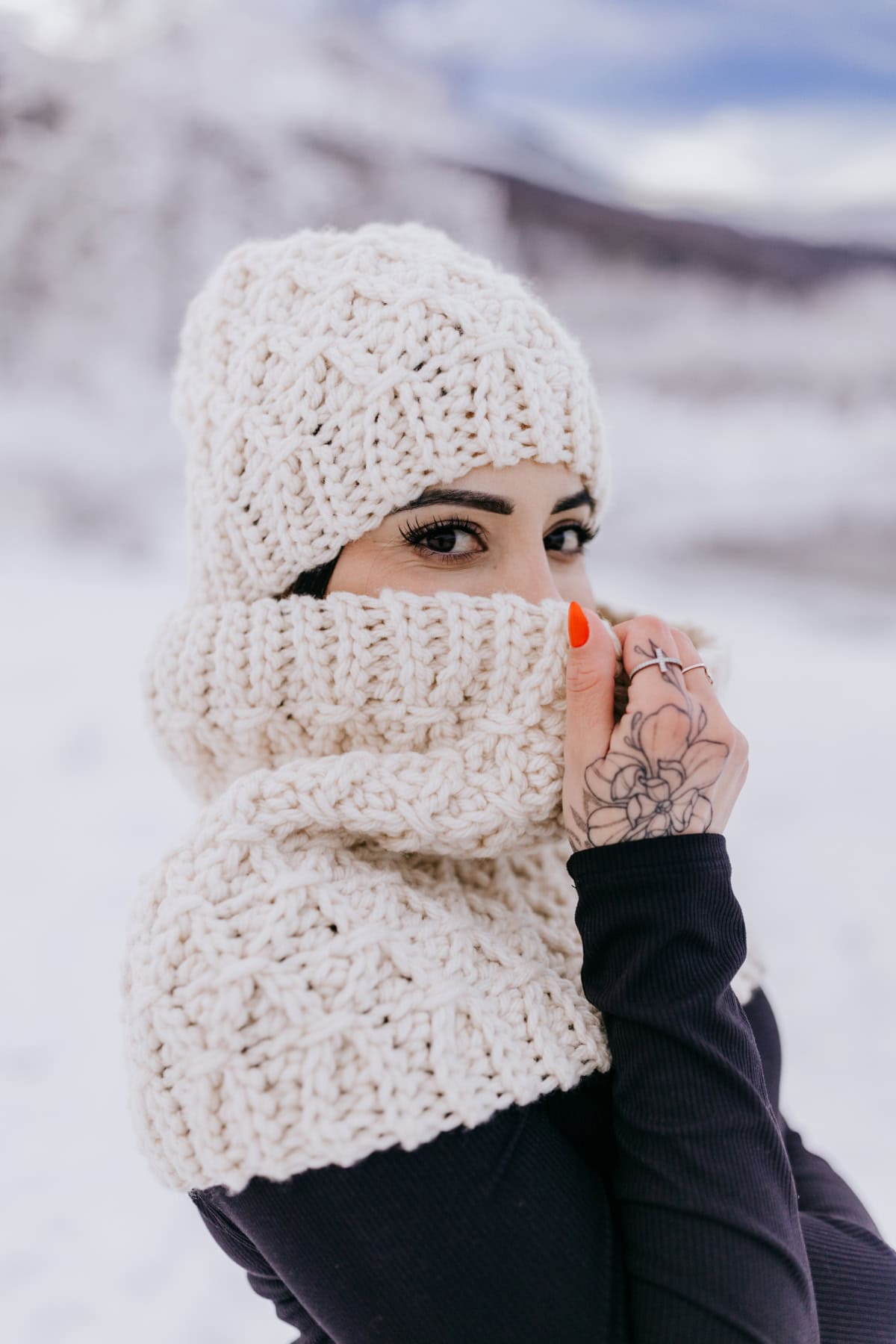 A knit look crochet beanie and cowl set in cream.