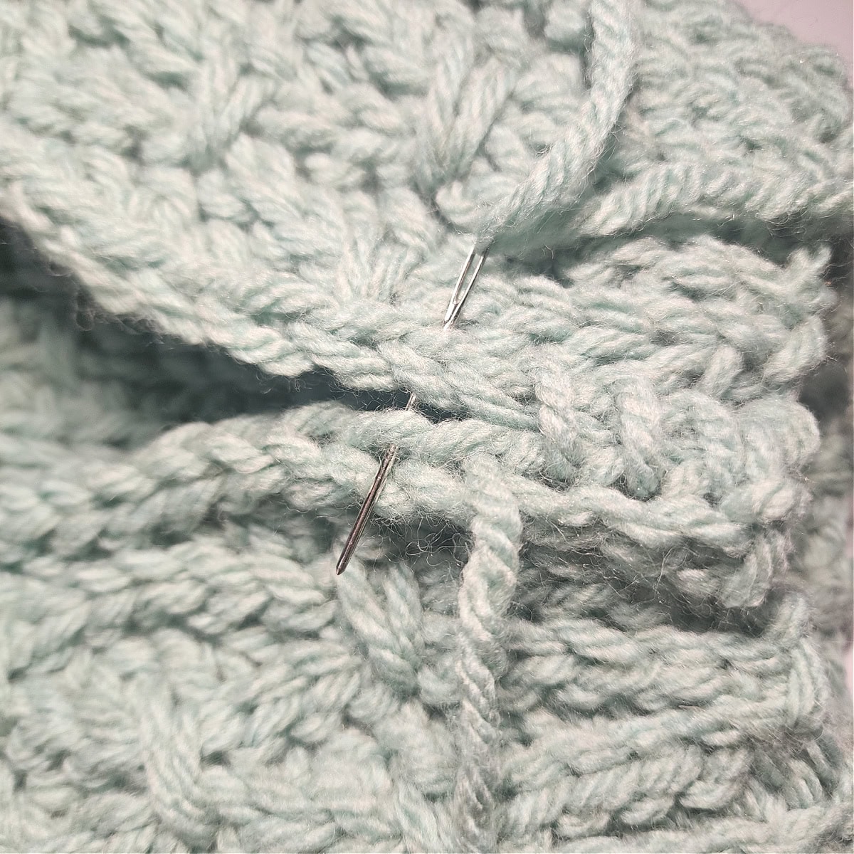 An inch of the whipstitch seam being worked on the crochet hat.