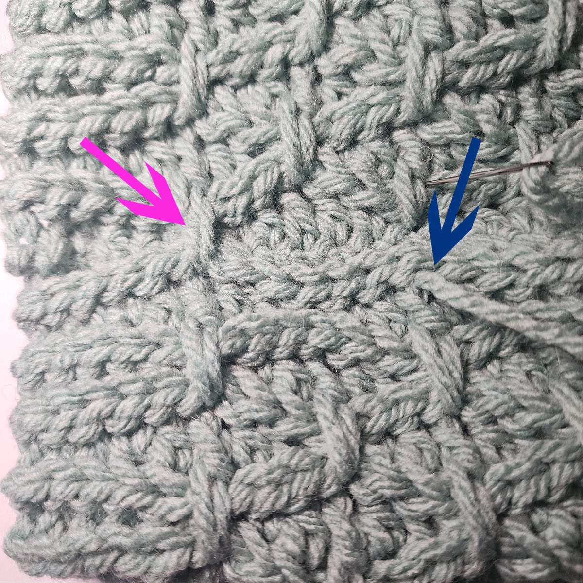 A pink arrow points to a completed finishing stitch and the blue arrow points to where the next one needs to be made.