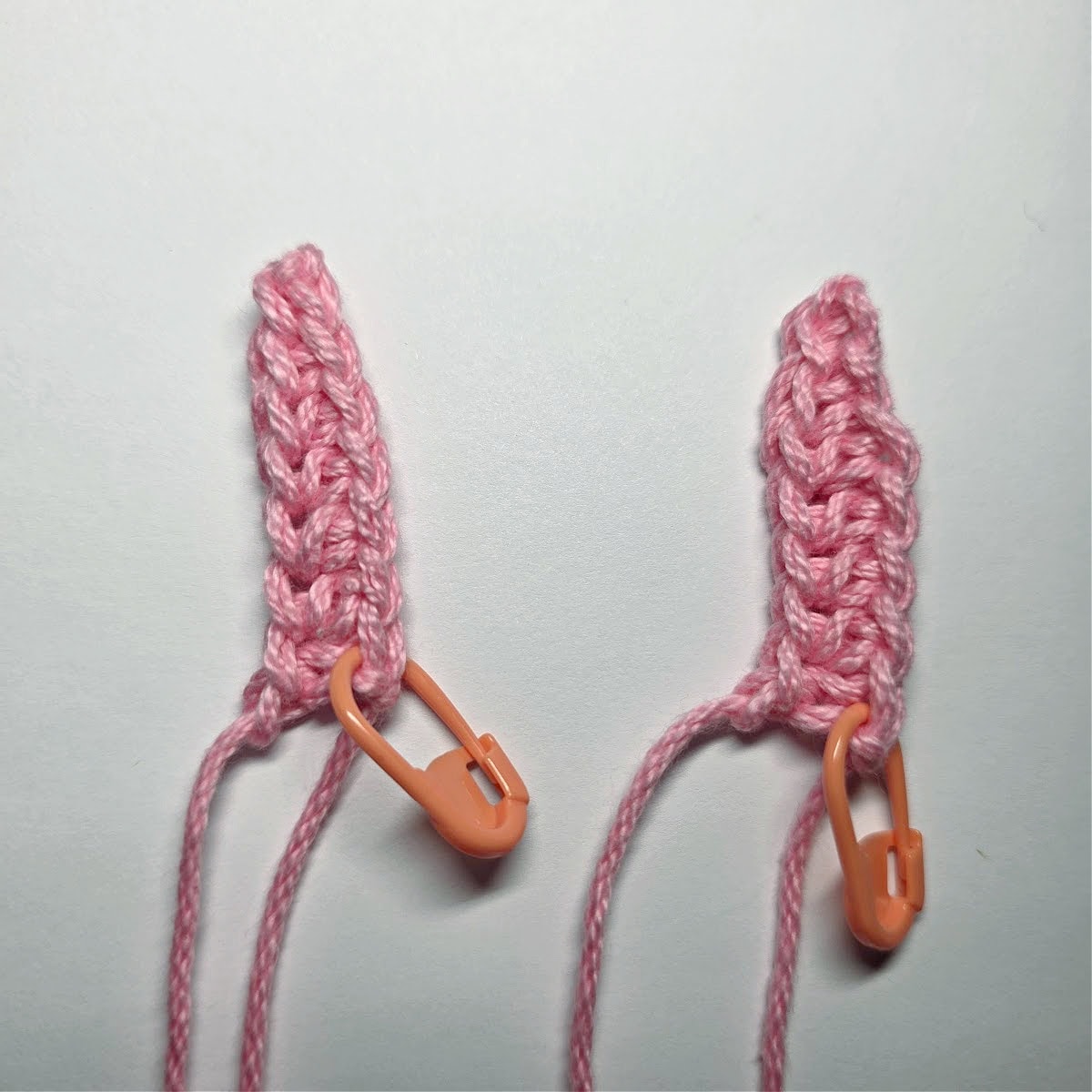 Two pink crochet triangles for inner bunny ears.