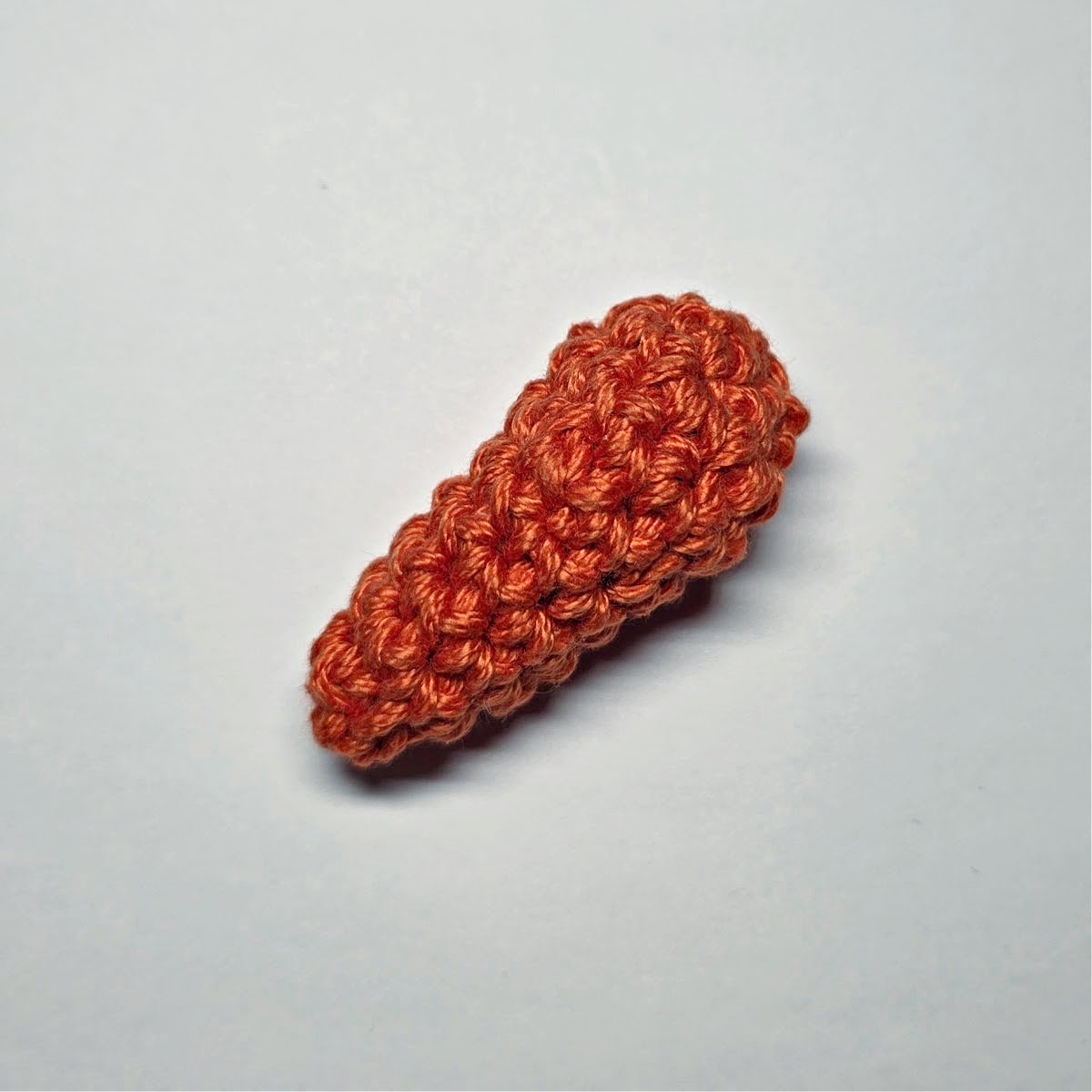 Mini crochet carrot without a green top.