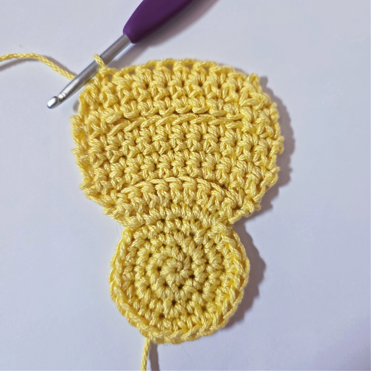 The bottom of the crochet baby chick is complete and ready to edge.