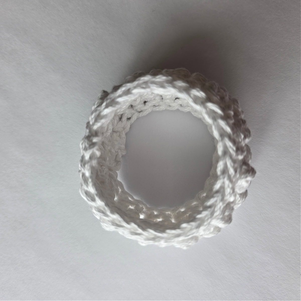 The top view of a crochet napkin ring with bobble stitches.