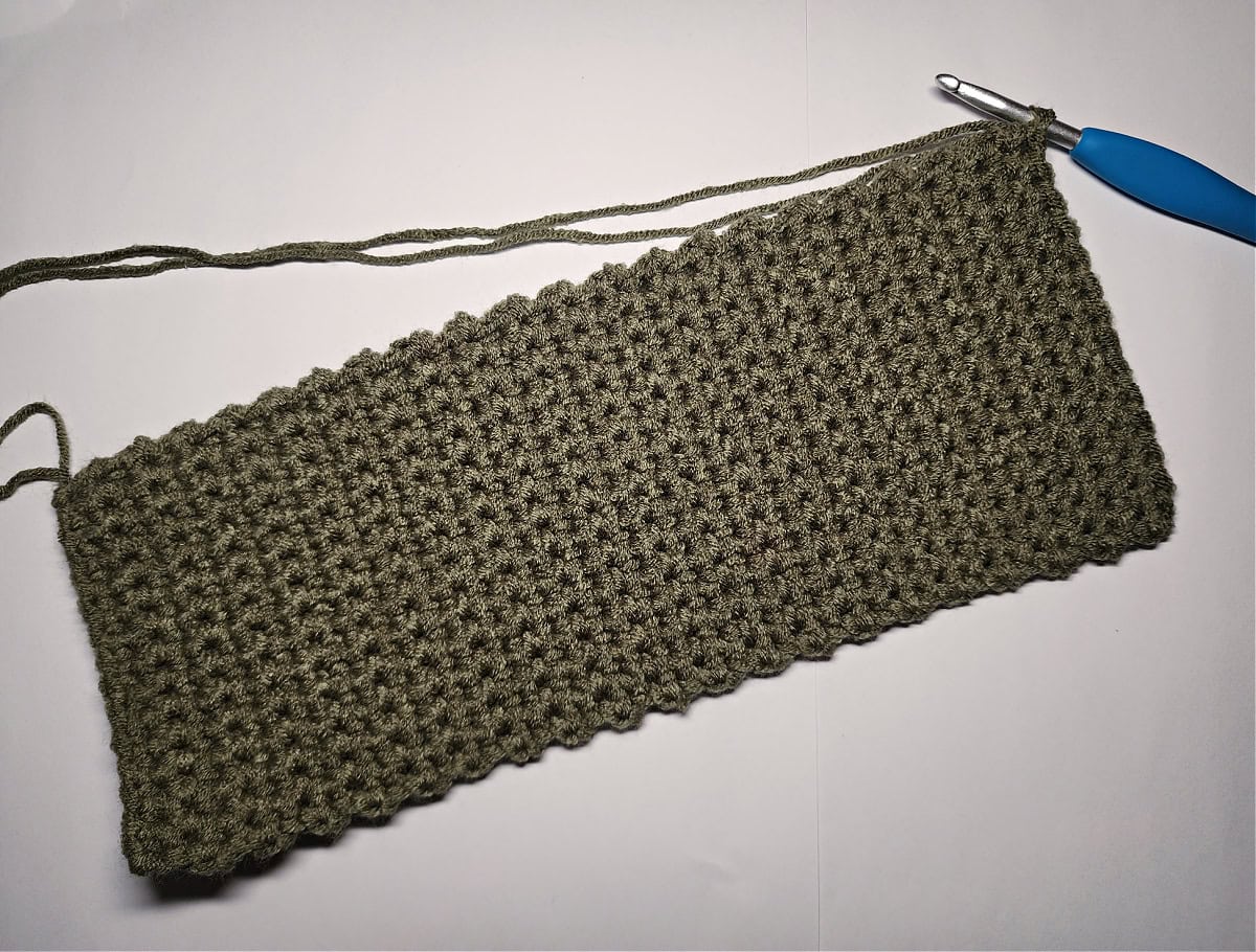 An olive green crochet rectangle for the base of a crochet purse.