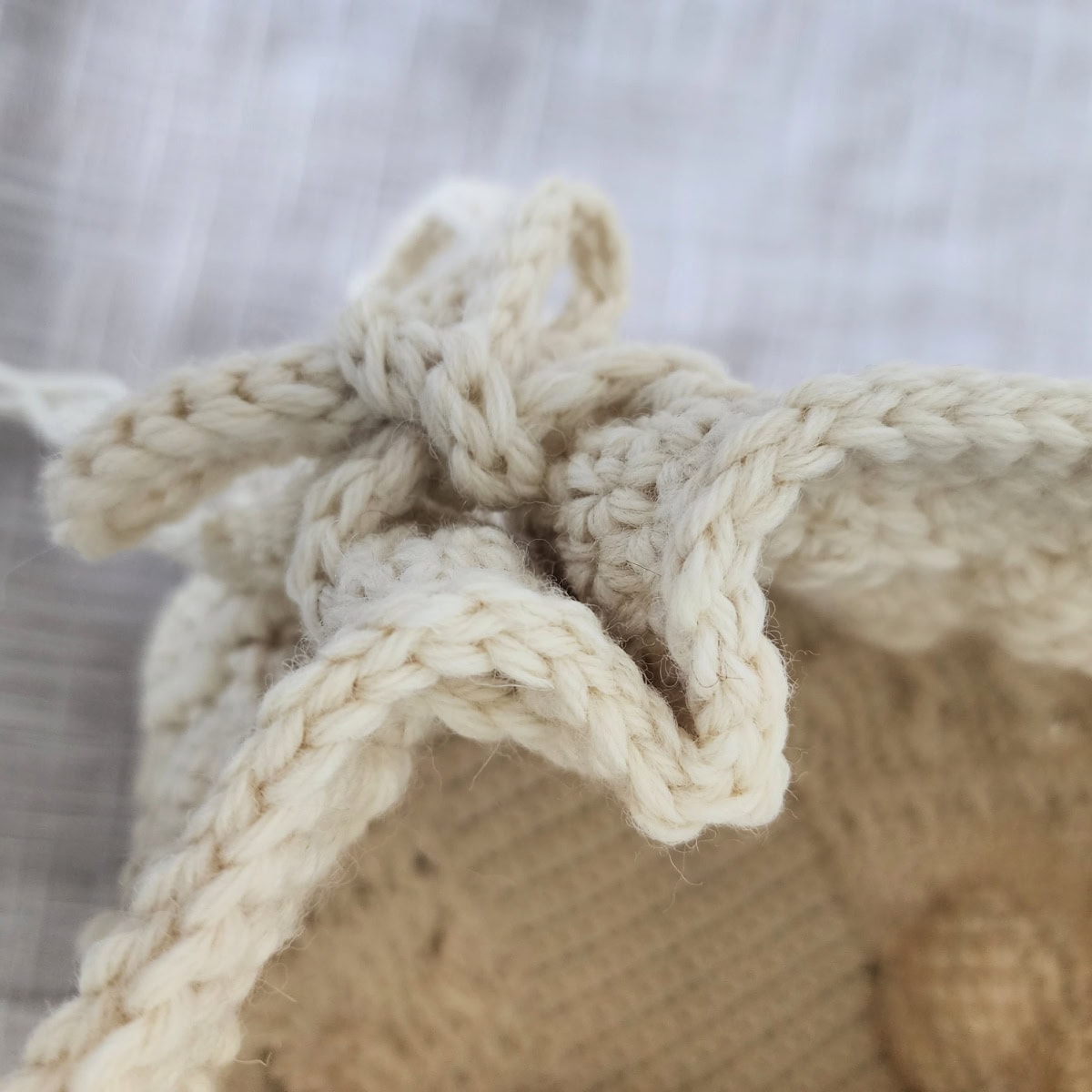 The top view of a pleat on the end of a crochet bag.