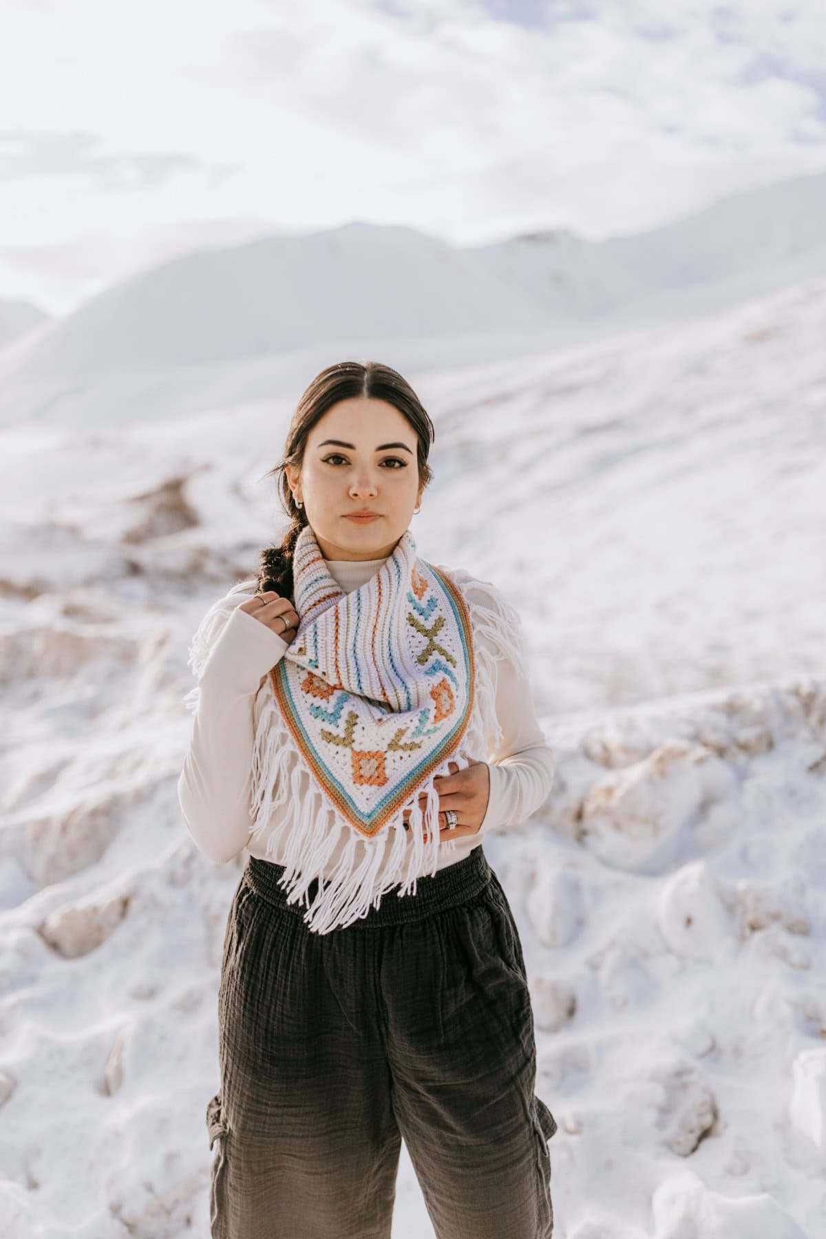 A crochet triangular scarf pattern made using intarsia colorwork for the granny stitches.