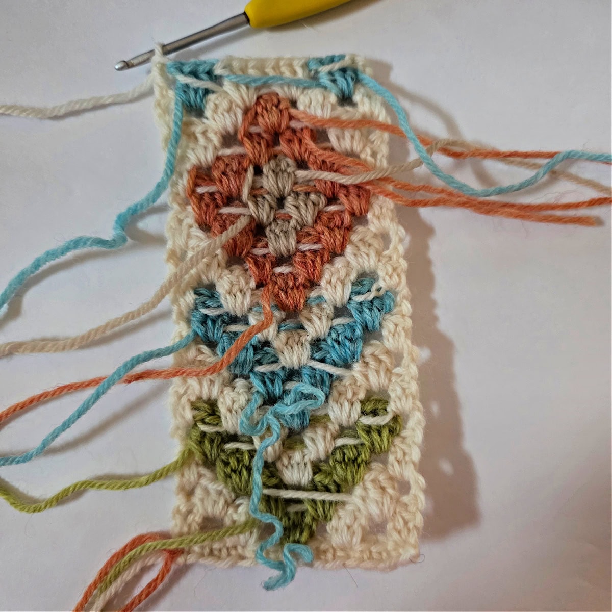 A granny stitch motif with color changes to create a diamond and arrow design.